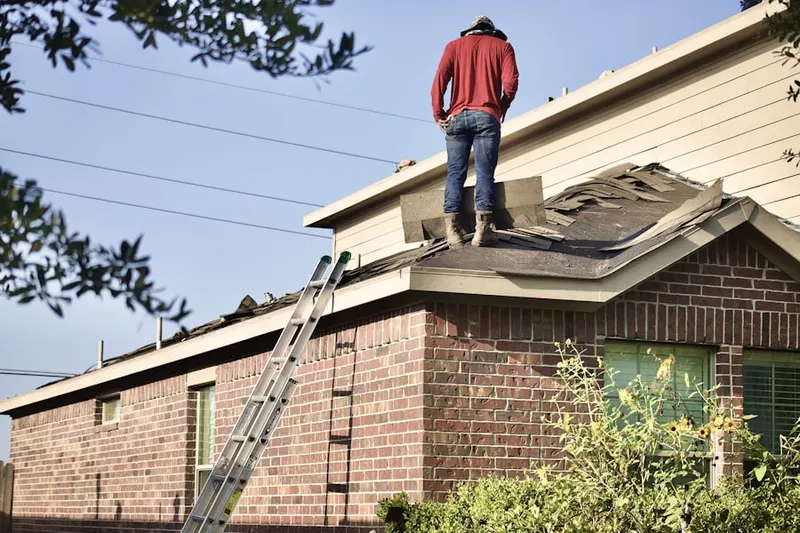 Professional roofer working on a residential roof in North Randolph